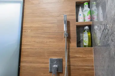 a bathroom door with bottles of bleach at Luxury & Modern Apartment - Rowing Canal Plovdiv in Plovdiv