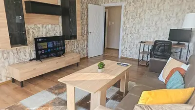 a living room with a couch and a table at One-Bedroom Apartment next to Mall Plovdiv with Free Street Parking in Plovdiv