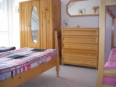 a bedroom with a wooden bed and a dresser at Iglika 2 Top Floor apartment in Borovets