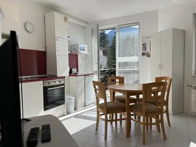 a kitchen with a table and chairs and a dining room at Iglika 2 Top Floor apartment in Borovets