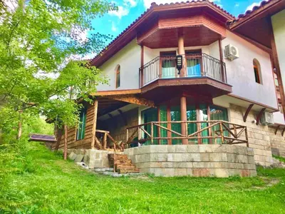 a house with a balcony on the side of it at Villa Pamporovo in Pamporovo
