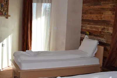 a bed sitting in a room with a window at Villa Pamporovo in Pamporovo