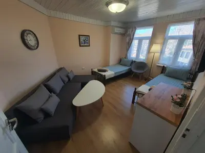 a living room with a couch and a table at Guest House Old City Plovdiv in Plovdiv