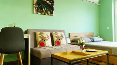 a living room with a couch and a table at The BlackPeak View Apartment in Sofia