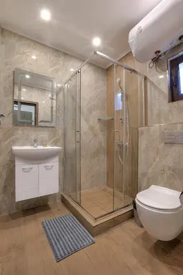 a bathroom with a shower and a toilet and a sink at Portata in Plovdiv