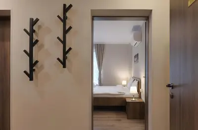 a door leading to a bedroom with a bed at Portata in Plovdiv