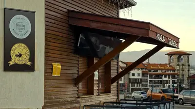 a group of tables outside of a building at LUXURY Designer Apt I Meters to Gondola Lift I Sleeps 6 I Pool & Parking I in Bansko