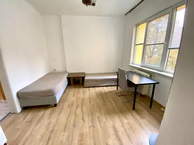 a room with a bed and a desk and windows at Happy Appointment in Sofia
