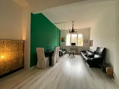 a living room with a couch and a green wall at Happy Appointment in Sofia