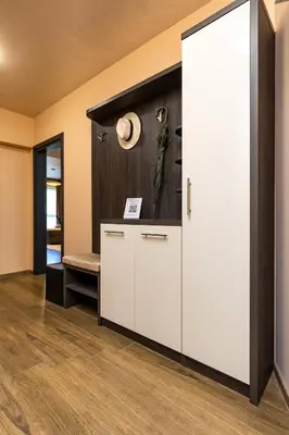 a room with a white cabinet with a hat on the wall at Warm and Spacious 1BR Apt - Brownie in Plovdiv