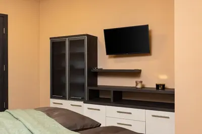 a living room with a tv on a wall at Warm and Spacious 1BR Apt - Brownie in Plovdiv