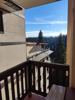 a balcony with a view of a building at Апартамент почивка в планината in Pamporovo