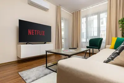 a living room with a netflix sign on a wall at Downtown apt Atelier 53 - Free Parking in Plovdiv
