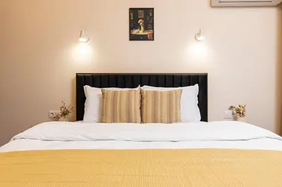 a bed with a black headboard and two pillows at Downtown apt Atelier 53 - Free Parking in Plovdiv