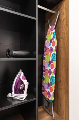 a surfboard on a shelf in a locker at Downtown apt Atelier 53 - Free Parking in Plovdiv