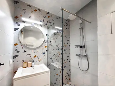 a bathroom with a shower and a sink and a mirror at Little Sugar Home in Sofia