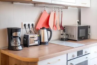 a kitchen counter with a microwave and a coffee maker at Old Town Bijou in Sofia