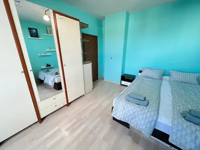 a bedroom with a bed and a large mirror at Lima 2BDR cozy Apt near Business Park w Work Desk in Sofia