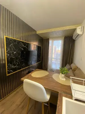 a living room with a wooden table and a couch at Beautiful 2BD Apartment with Large Terrace and Free Parking in Plovdiv