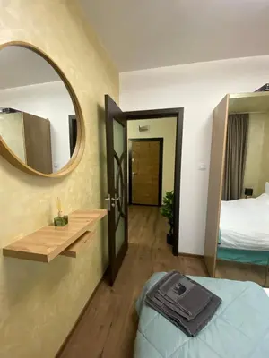 a hotel room with a mirror and a bed at Beautiful 2BD Apartment with Large Terrace and Free Parking in Plovdiv