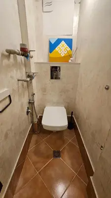 a small bathroom with a toilet in a stall at Cozy spot at the heart of Sofia in Sofia