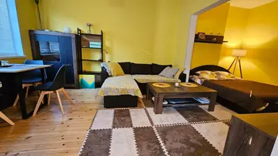 a living room with a couch and a table at Cozy spot at the heart of Sofia in Sofia