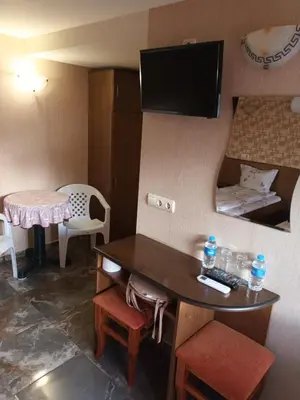 a small room with a small table and a small bed at Къща за гости Орешака in Oreshak