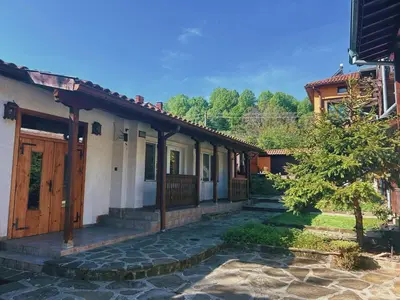 a house with a stone walkway in front of it at Къща за гости Орешака in Oreshak
