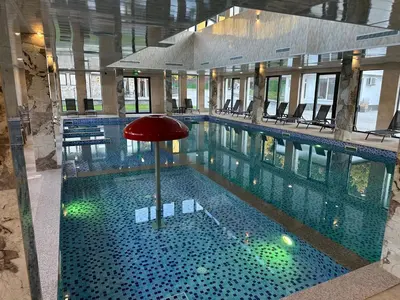 a swimming pool with a red umbrella in a building at Devin River in Devin