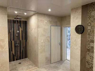a room with a clock and a walk in shower at Devin River in Devin