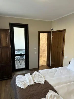 a bedroom with a large bed with towels on it at Devin River in Devin