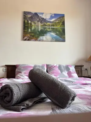 a pile of towels on top of a bed at Snow Apartment Bansko Home2Host in Bansko