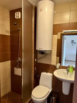 a small bathroom with a toilet and a sink at Snow Apartment Bansko Home2Host in Bansko