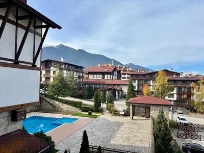 a resort with a swimming pool and buildings at Snow Apartment Bansko Home2Host in Bansko