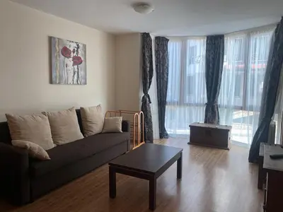a living room with a couch and a coffee table at Kandahar Apartment - top location in Bansko