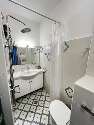 a white bathroom with a sink and a toilet at Bogota Central Apt w Office Space and Wifi near Metro in Sofia