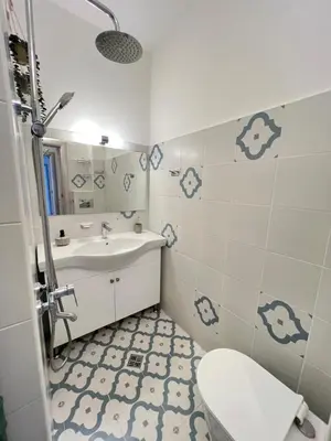 a bathroom with a white sink and a toilet at Bogota Central Apt w Office Space and Wifi near Metro in Sofia