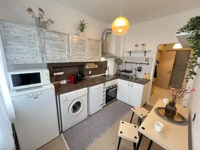 a kitchen with a washer and dryer and a table at Bogota Central Apt w Office Space and Wifi near Metro in Sofia