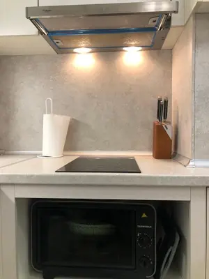 a kitchen with a counter top with a microwave at Artistic Neon Apartment in Bansko