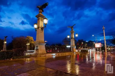a monument with a bird on top of it at night at Gogol 2BR Apartment in Sofia