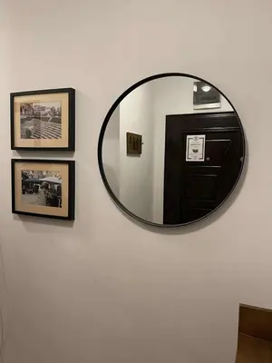 a mirror on a wall with pictures on a wall at Heart of Plovdiv - 2 bedrooms, Private garage in Plovdiv