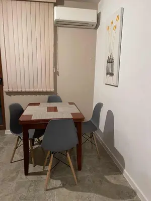 a dining room table and chairs in a room at Heart of Plovdiv - 2 bedrooms, Private garage in Plovdiv