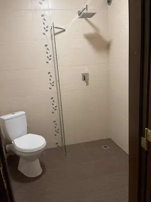 a shower stall with a toilet in a bathroom at Heart of Plovdiv - 2 bedrooms, Private garage in Plovdiv