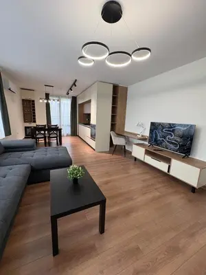 a living room with a couch and a table at New Urban Stay Airport city center metro access in Sofia