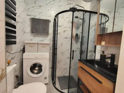 a bathroom with a washing machine and a sink at Charming Studio 88 in Bansko