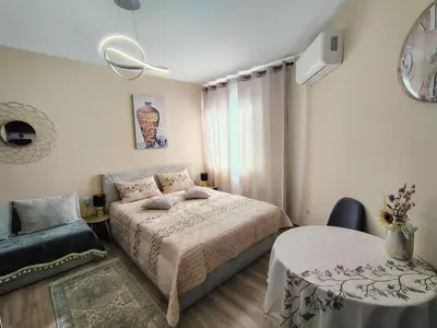 a bedroom with a bed and a table at Charming Studio 88 in Bansko