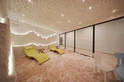 a room with two yellow chairs and a wave mural at Hotel Complex SamElyon in Samokov