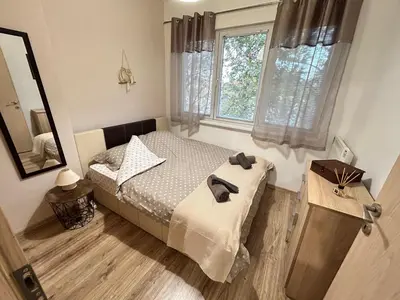 a small bedroom with a bed and a mirror at Sunlight Suite - free private parking - central in Plovdiv