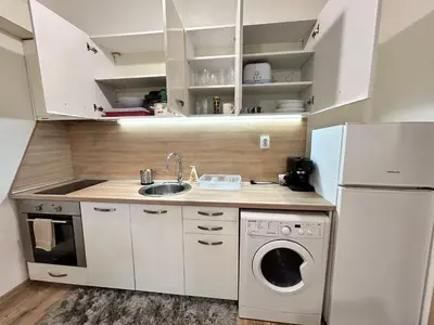 a kitchen with a sink and a washing machine at Sunlight Suite - free private parking - central in Plovdiv