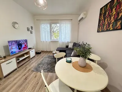 a living room with a table and a couch at Sunlight Suite - free private parking - central in Plovdiv
